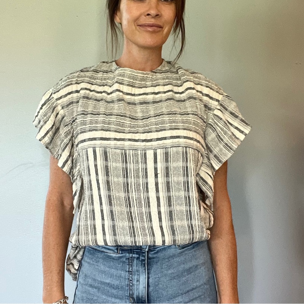 Cream and blue striped top.